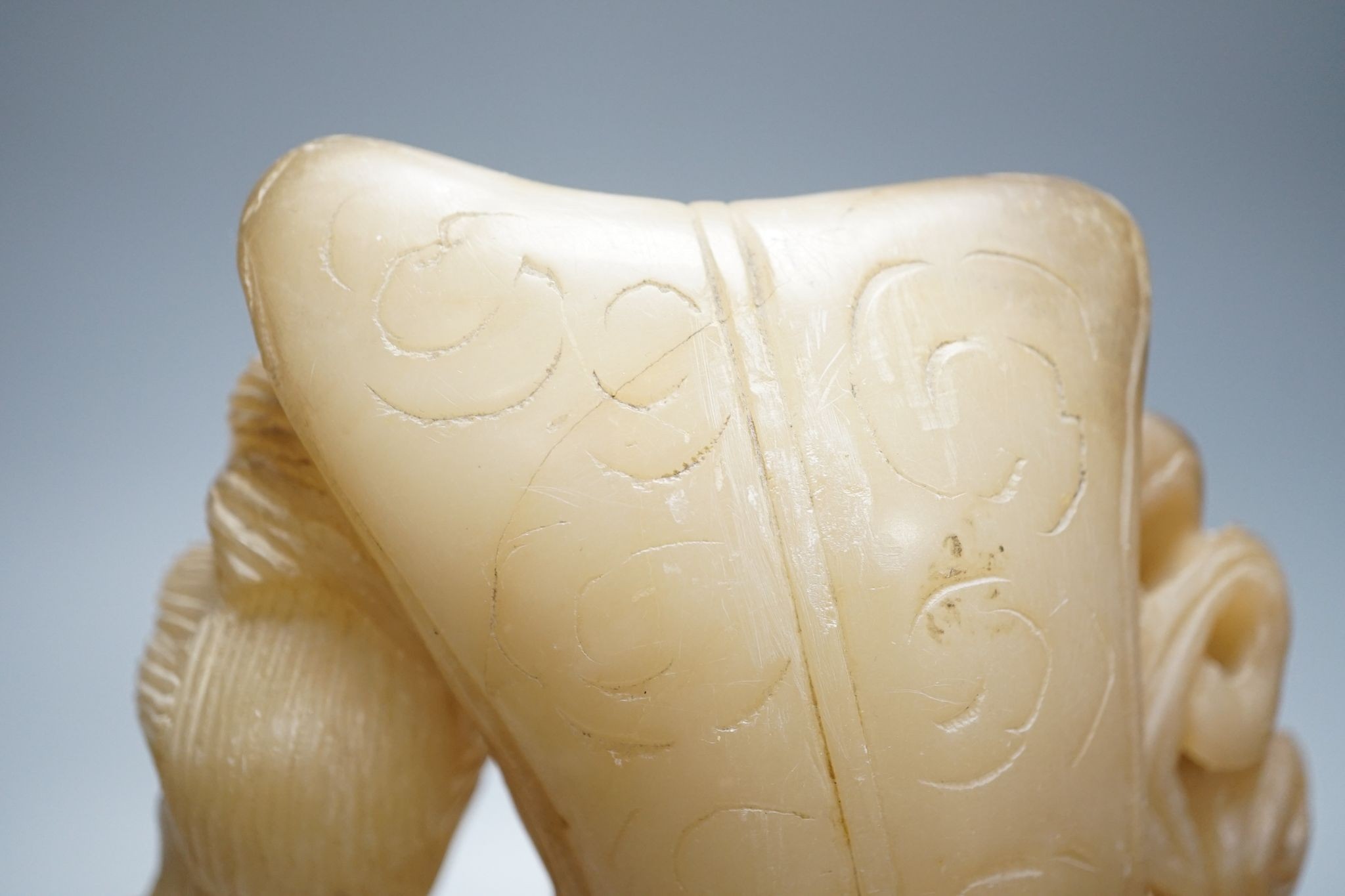 A Chinese soapstone carving of two ladies, wood stand, early 20th century, 36 cms high.